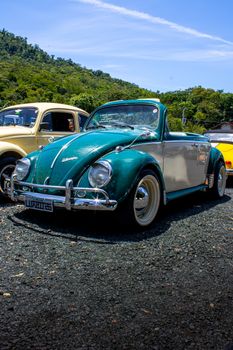 Vintage Volkswagen Beetle showcased outdoors in Santa Catarina, Brazil.