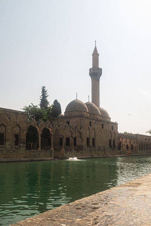 Free Stunning view of a historic mosque with calm waters reflecting its beauty. Stock Photo