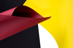 Abstract curved paper in crimson and yellow — photo by Valentin Ivantsov on Pexels
