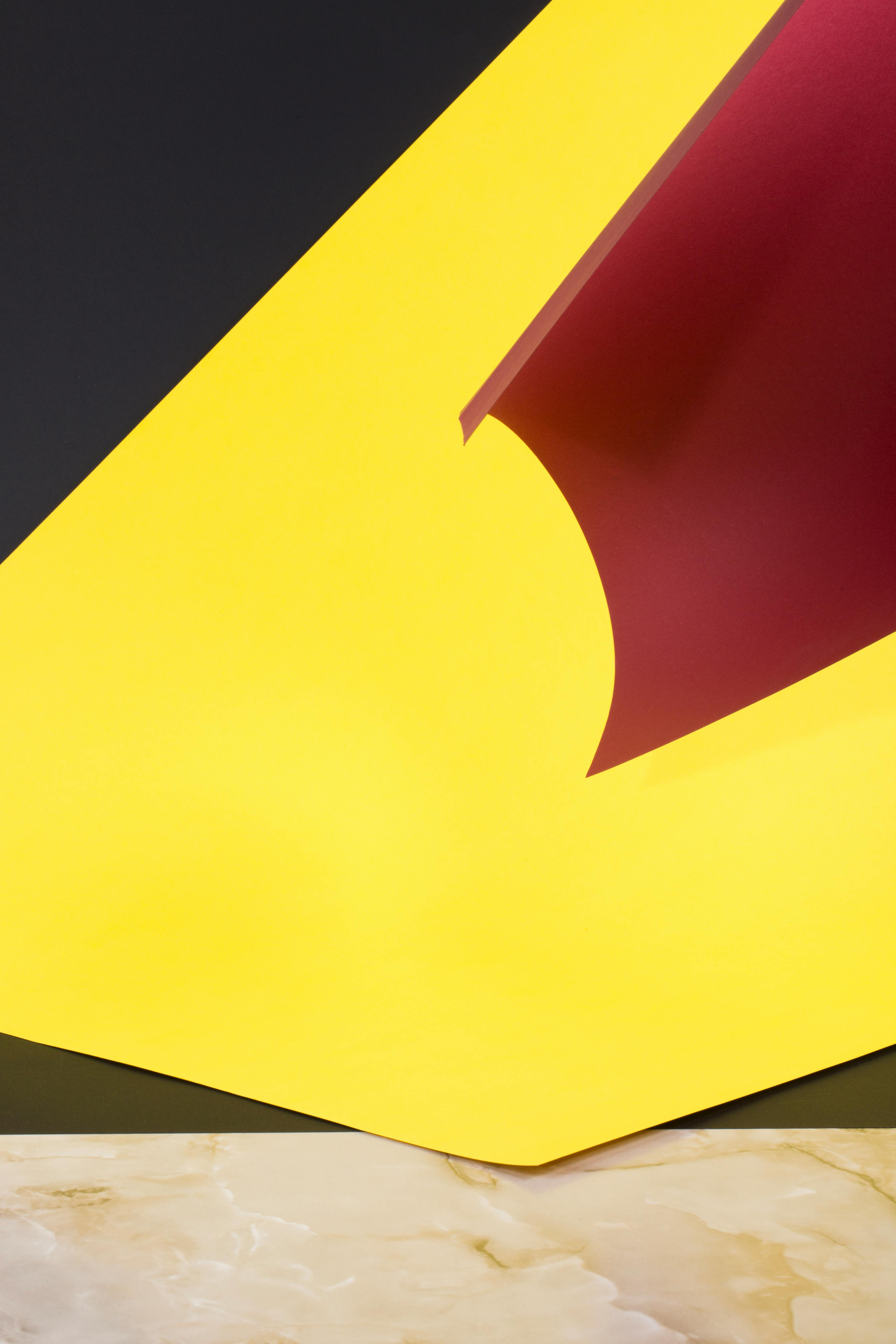 gratis Dynamisch abstract ontwerp met opvallende gele en rode vormen op een marmeren achtergrond. Stockfoto