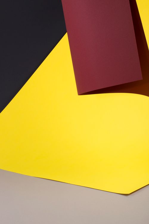 Free Abstract composition with bold red, yellow, and black geometric shapes in limited lighting. Stock Photo