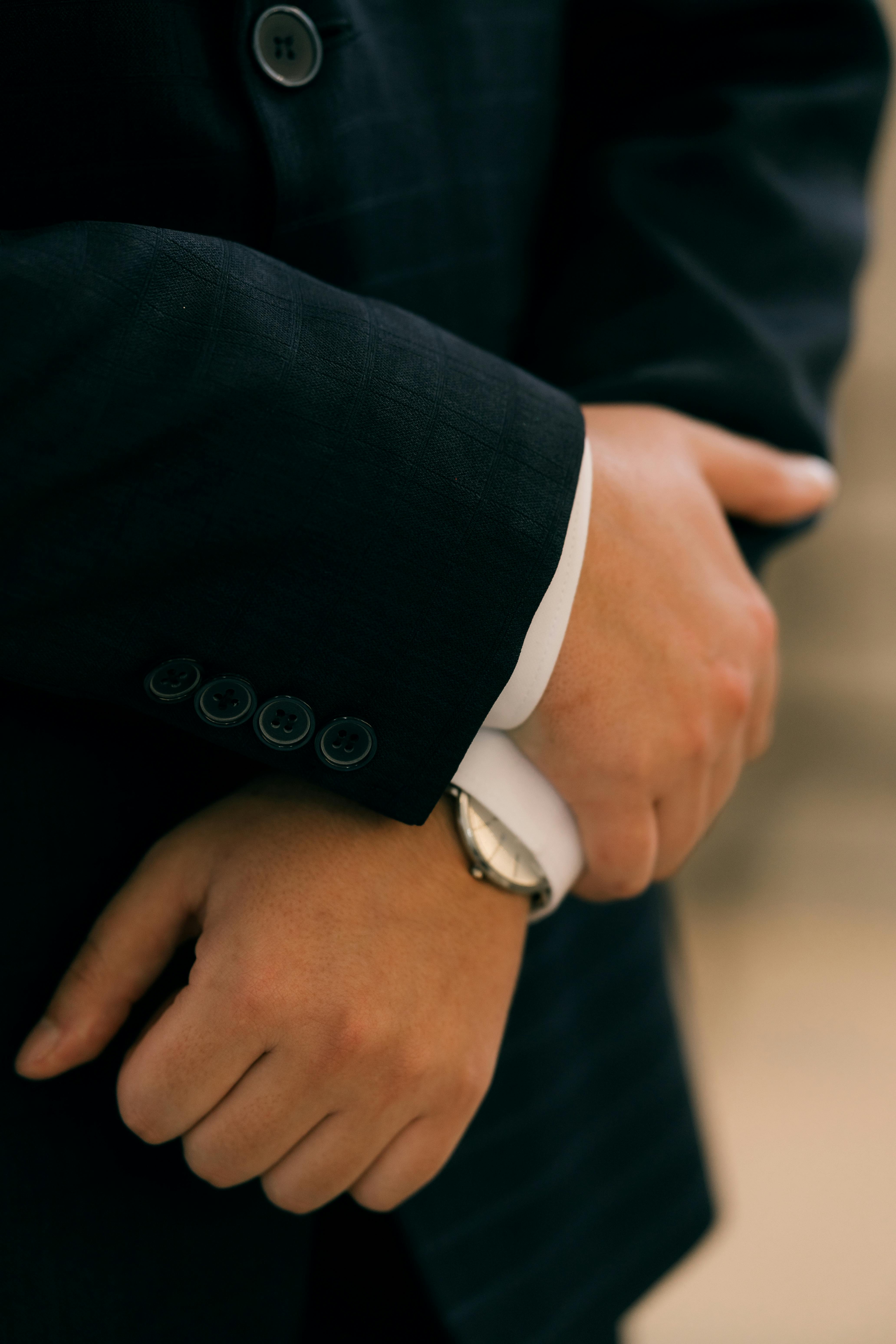 Free Close-up of a man's hands in a formal suit, exuding professionalism and confidence. Stock Photo