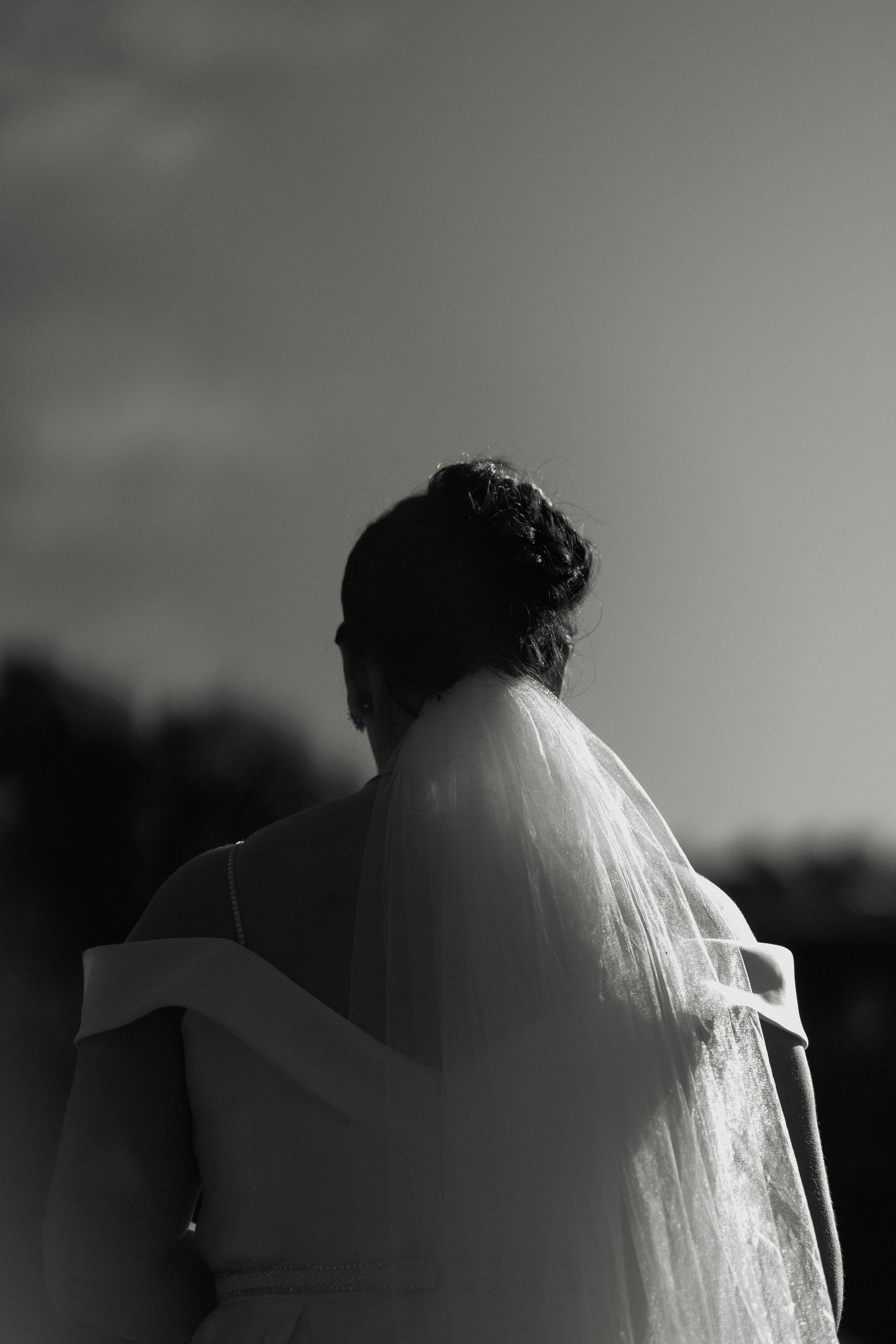Ilmainen Klassinen mustavalkoinen kuva morsiamesta takaapäin katsottuna, joka korostaa eleganssia ja yksinkertaisuutta. Kuvapankkikuva