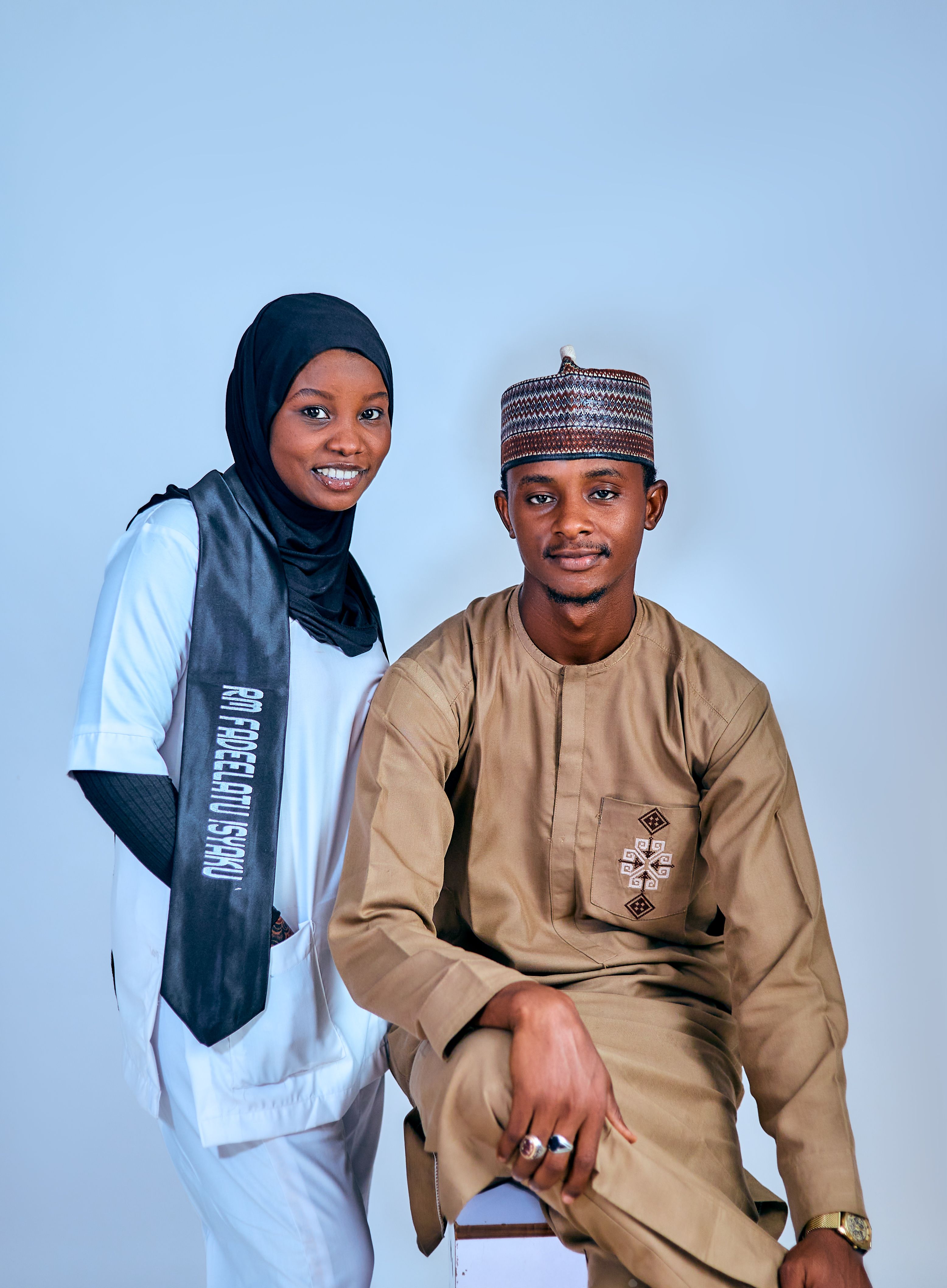 Young adults in traditional and modern attire posing happily for a portrait.