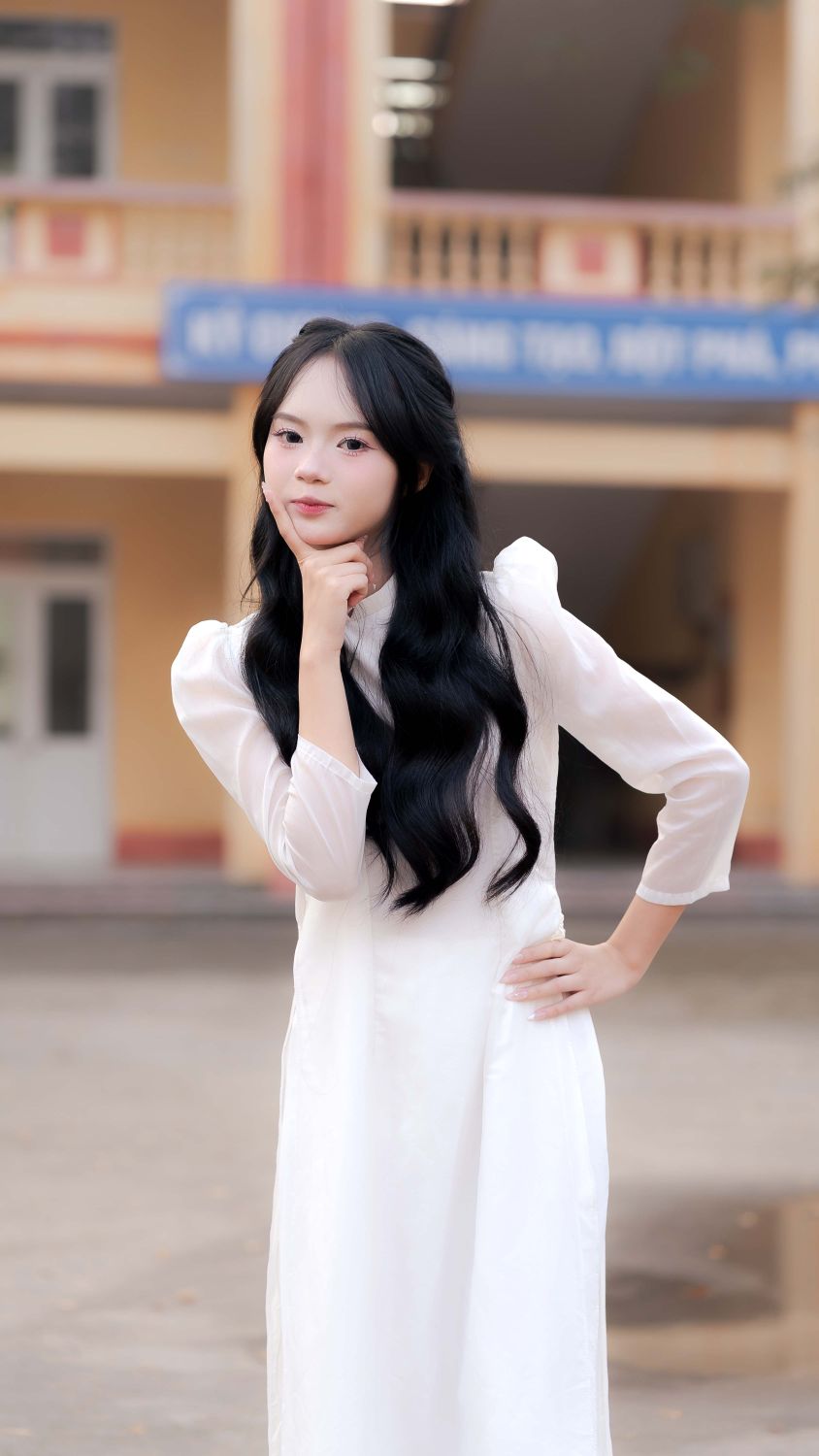 Young woman in traditional white dress posing outdoors · Free Stock Photo