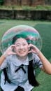 Smiling Girl with a Giant Bubble Outdoors
