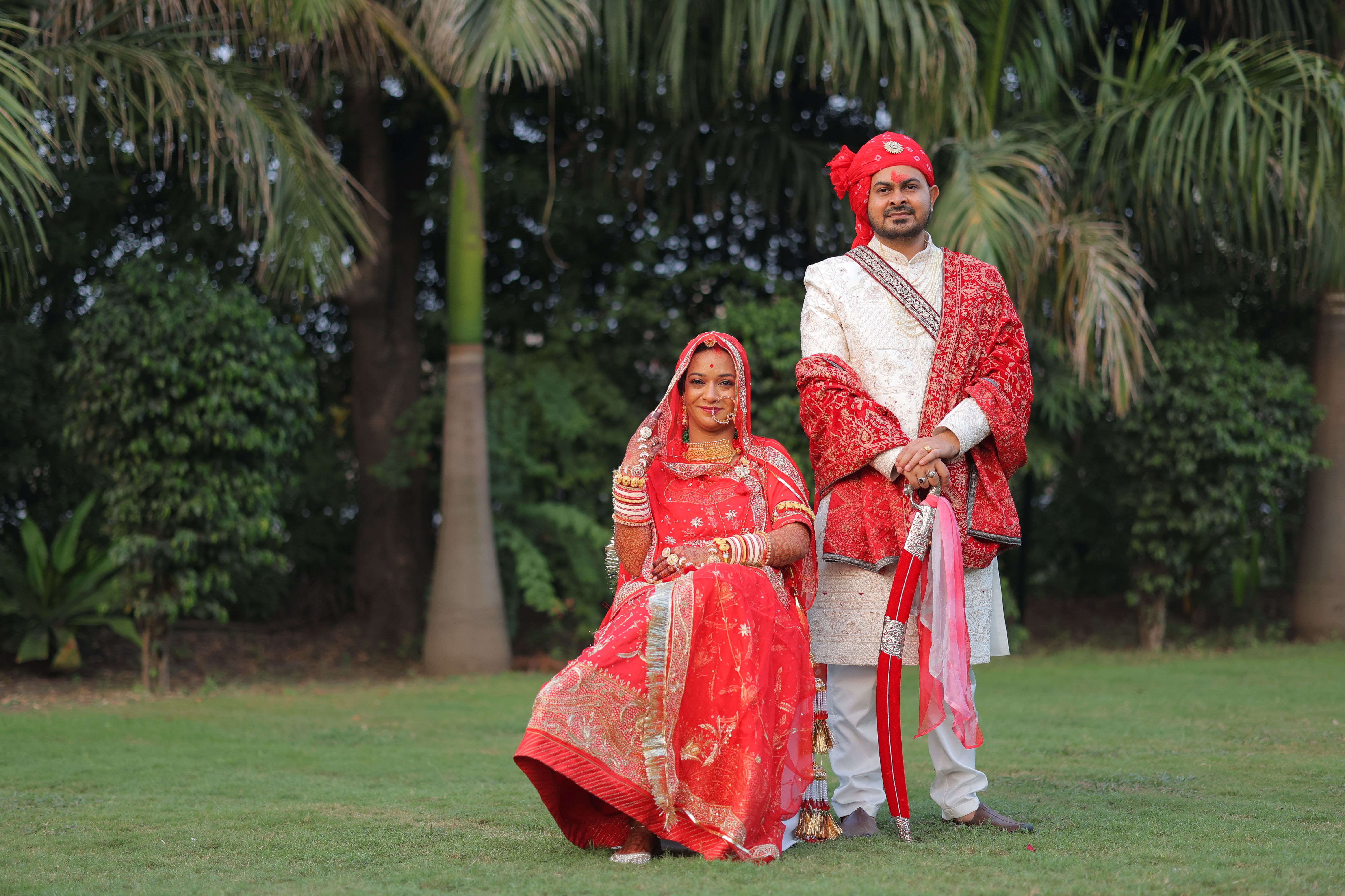 A couple in traditional Indian attire during an outdoor wedding photoshoot.