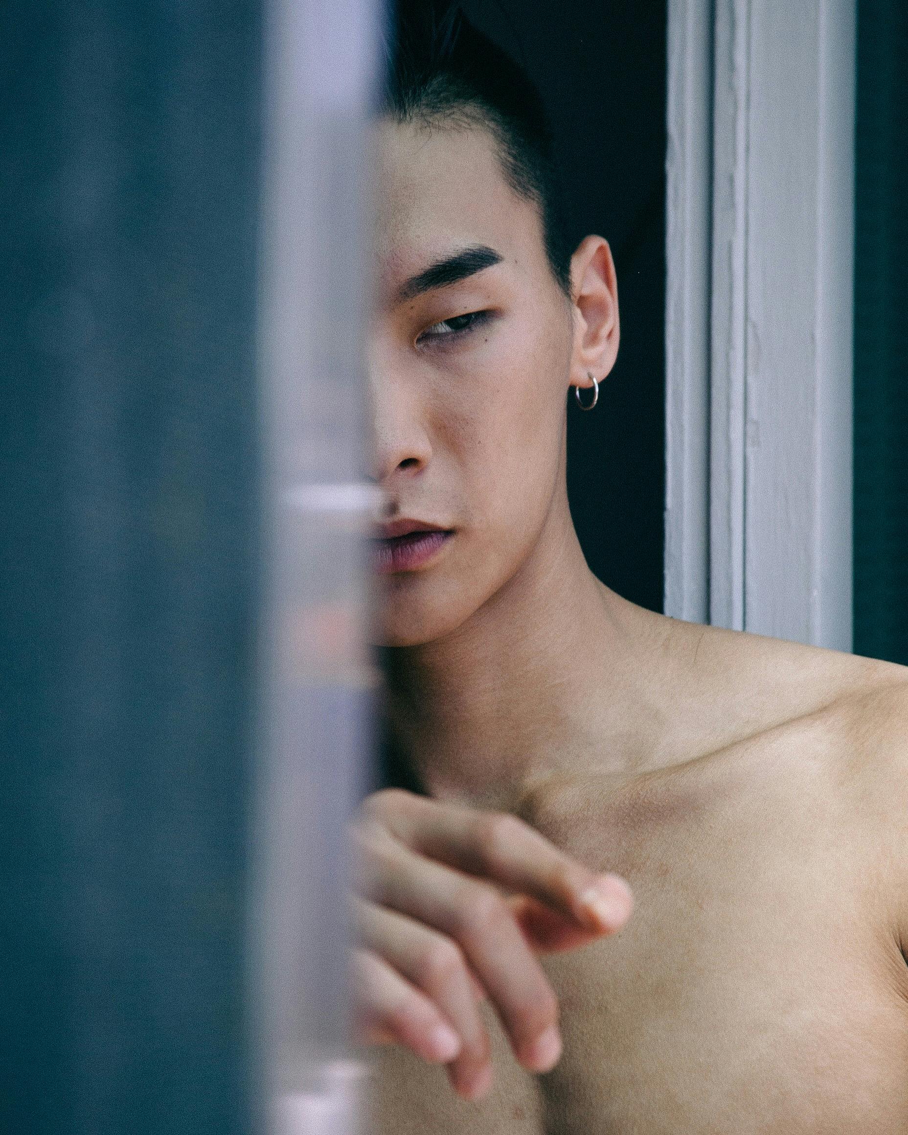 A striking portrait of a young man with an artistic composition, highlighting minimalism and intrigue.