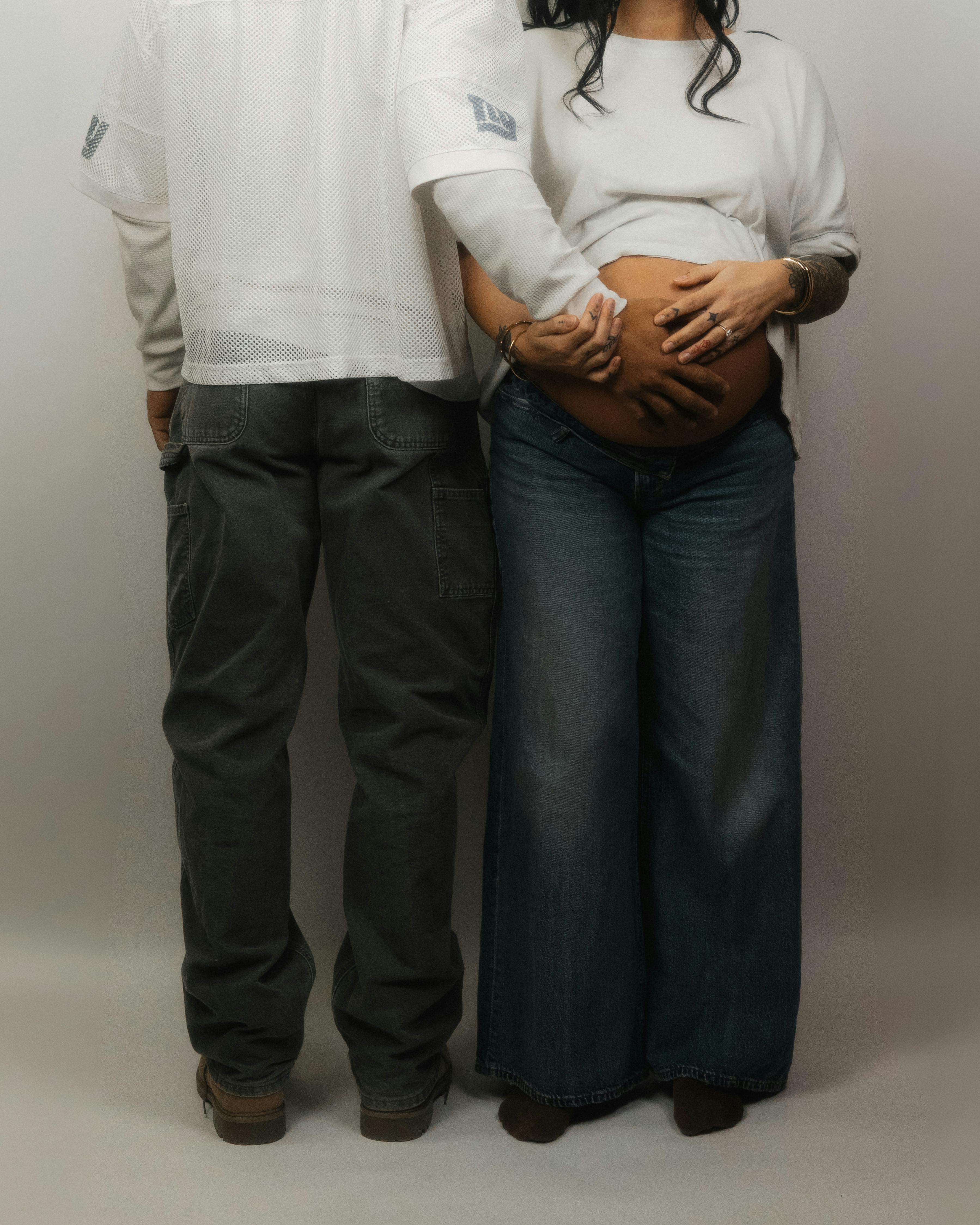 Free A couple stands together, embracing their pregnancy with love and anticipation. Stock Photo