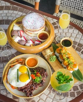 Delectable brunch spread featuring pancakes, steak, sushi, and drinks in Miami, Florida.