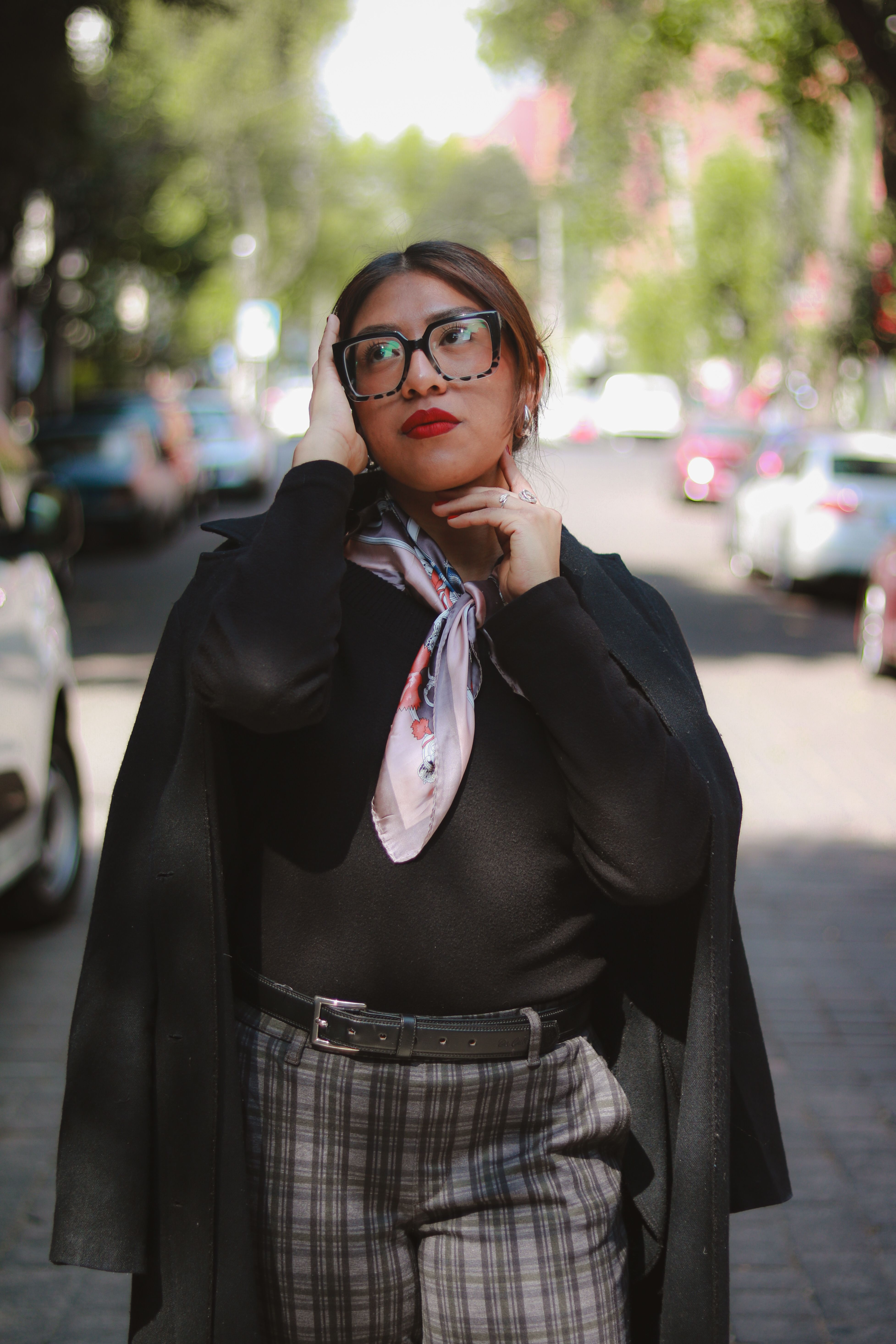 Stylish Woman Posing in a Sunlit Urban Street · Free Stock Photo