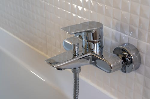 Free Stainless Steel Faucet on White Ceramic Sink Stock Photo