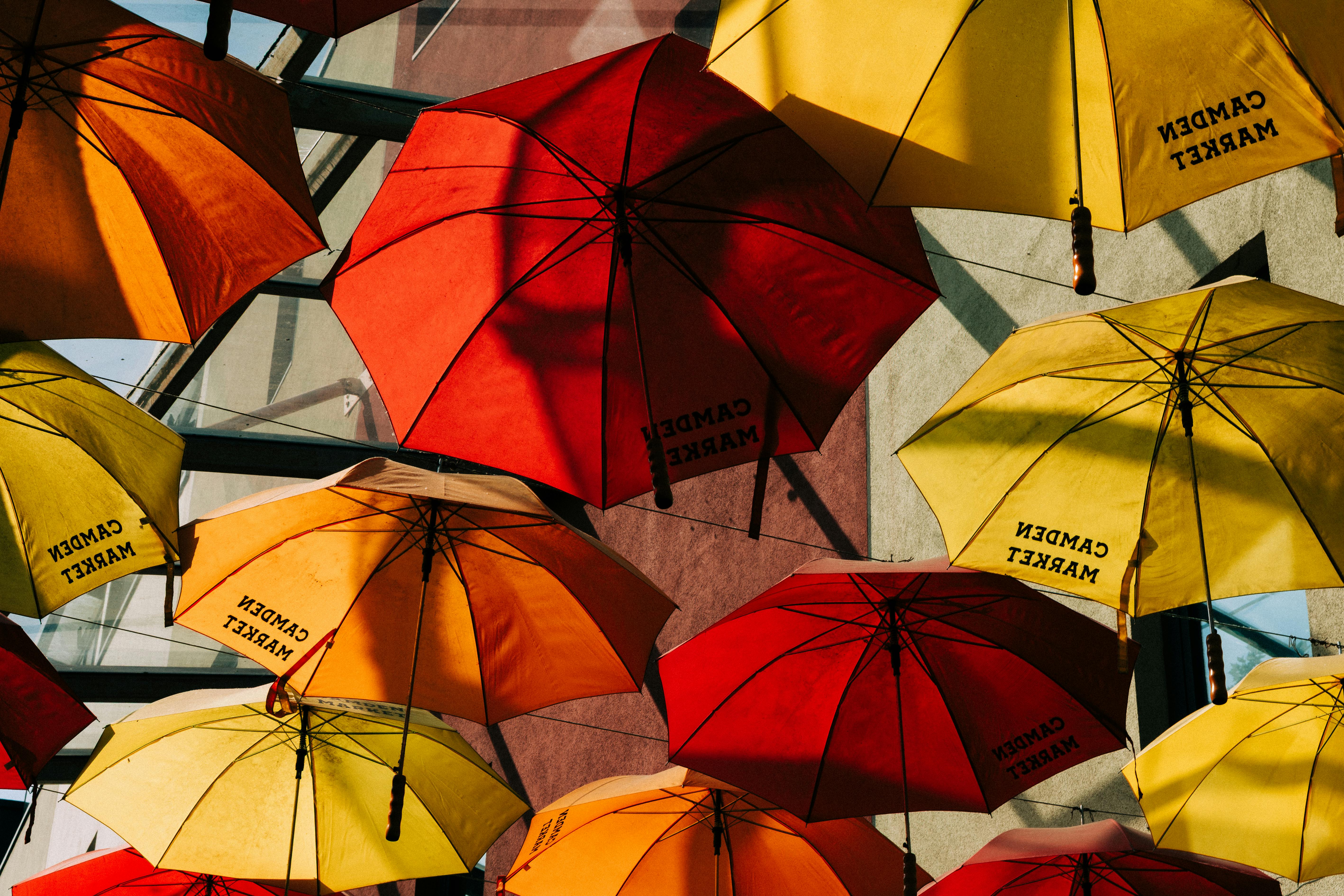 Vibrant red and yellow umbrellas at Camden Market, London, creating a lively and artistic atmosphere.