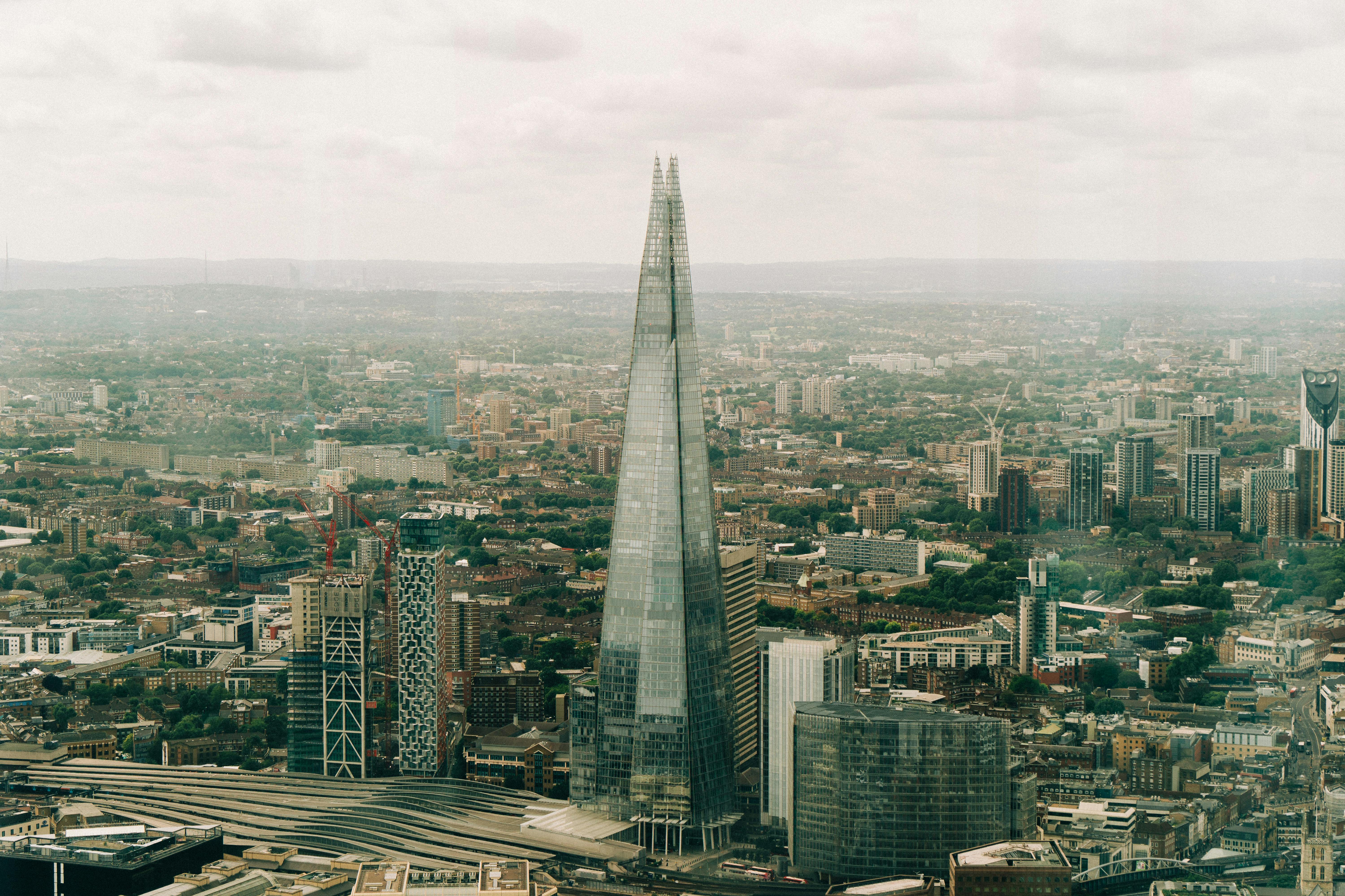 Stunning aerial view of The Shard and London's urban skyline on a cloudy day.