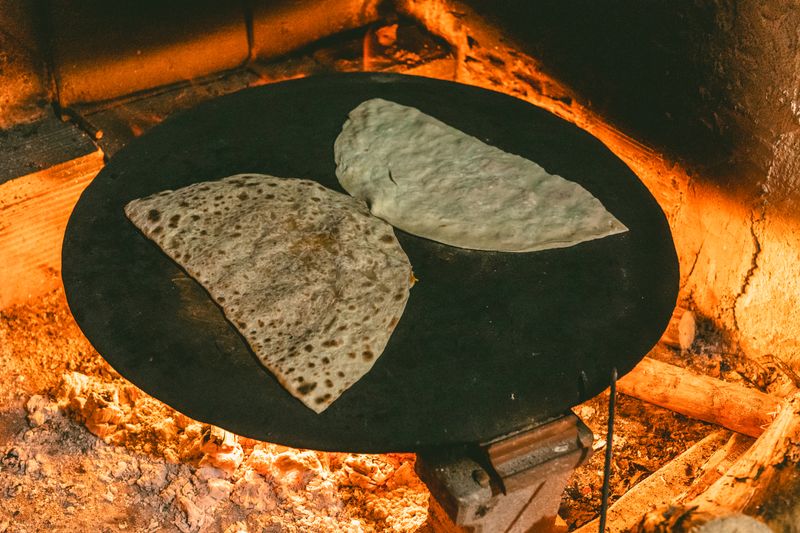 Gozleme being cooked on a sac griddle