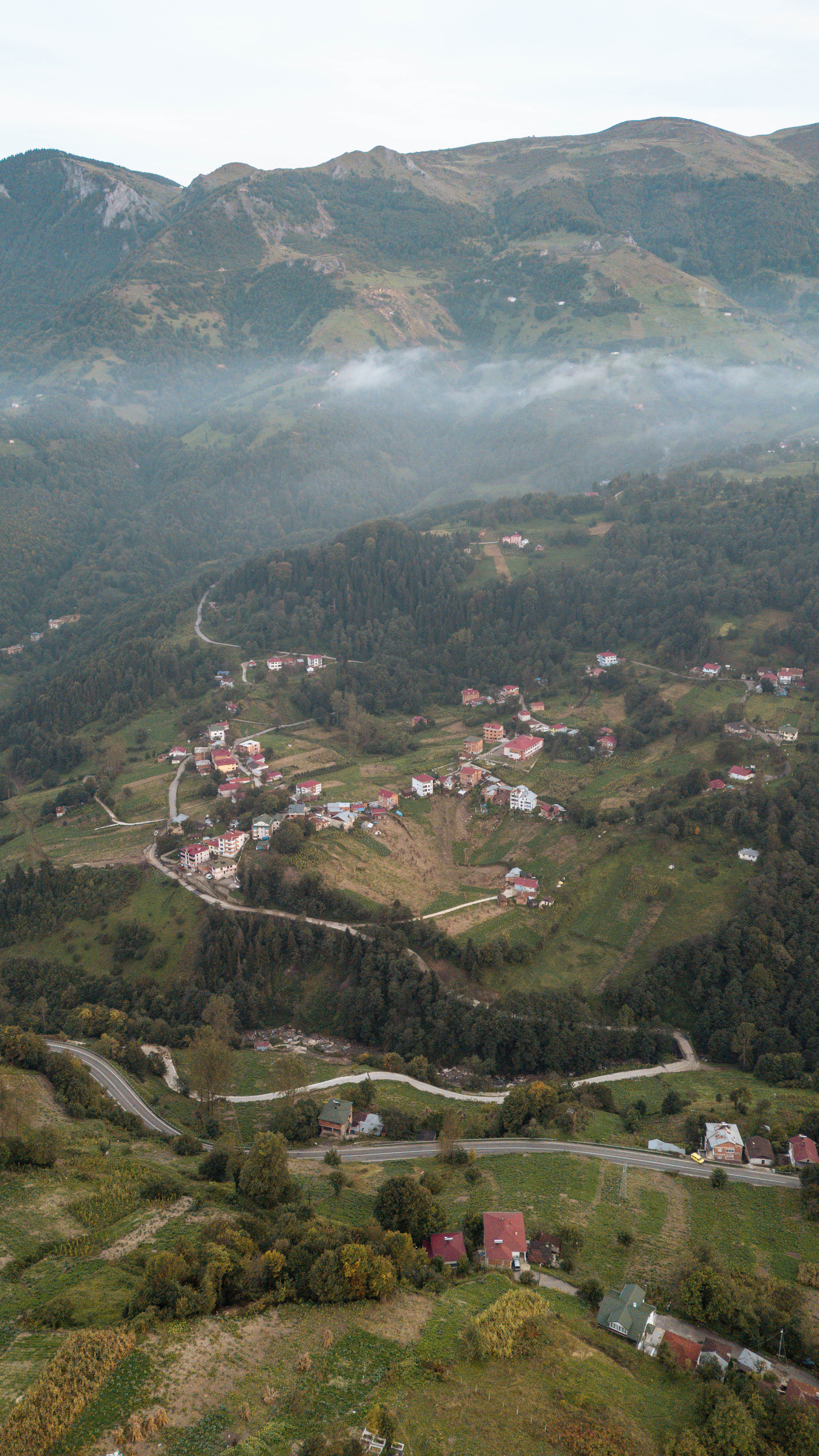 Aerial View of Village in Mountainous Landscape · Free Stock Photo