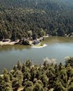 Scenic Aerial View of Lake House Surrounded by Forest