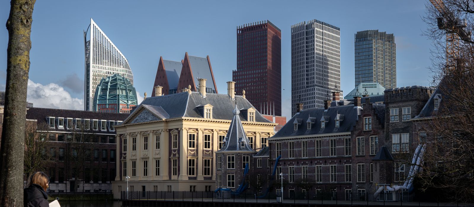 View of The Hague skyline and historic buildings along the canal, featuring modern and classic architecture.