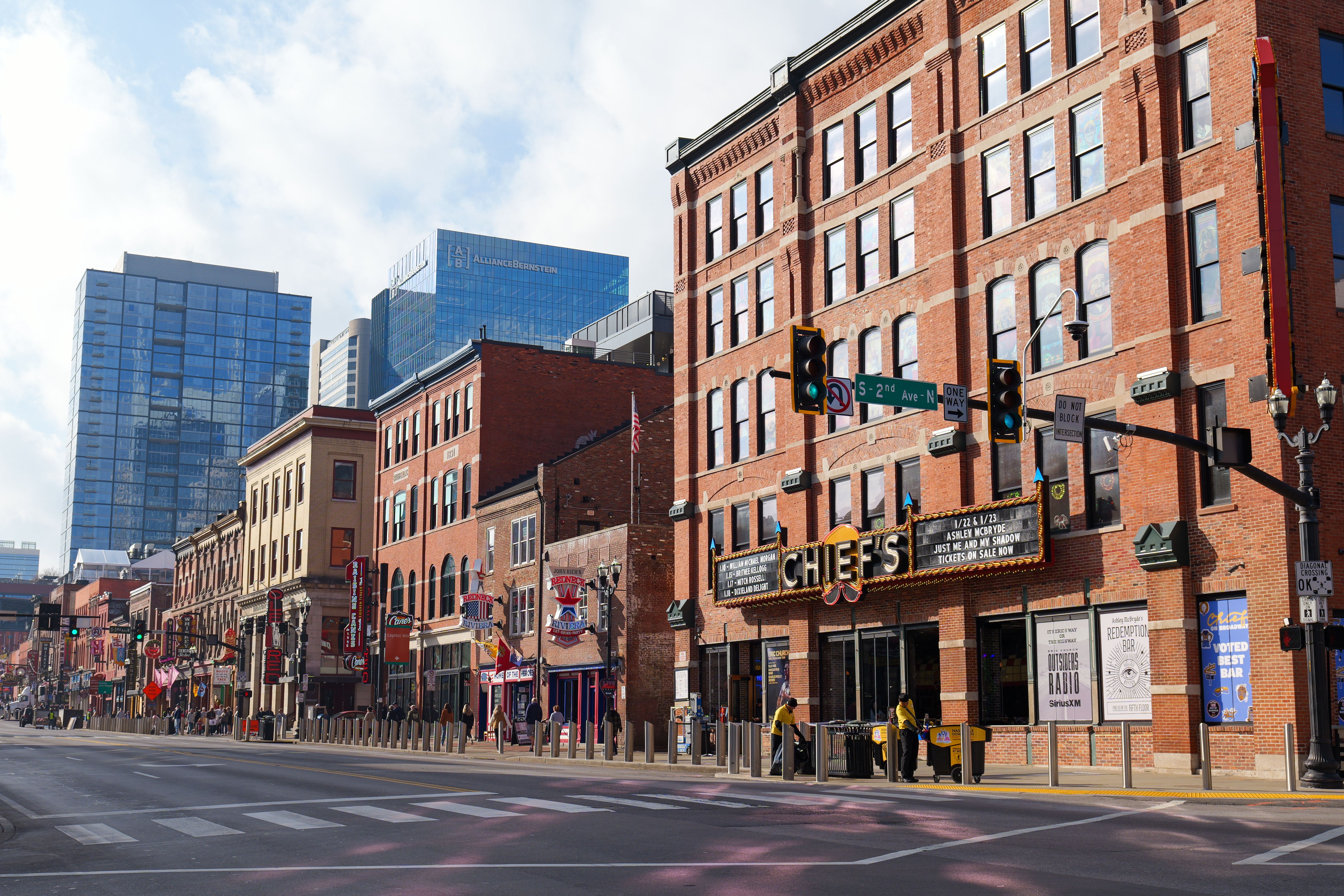 Explore the lively streets of downtown Nashville, showcasing historic brick buildings under a bright sunny sky.