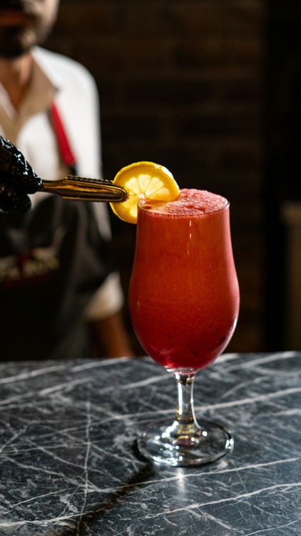 Refreshing Red Cocktail with Lemon Garnish · Free Stock Photo