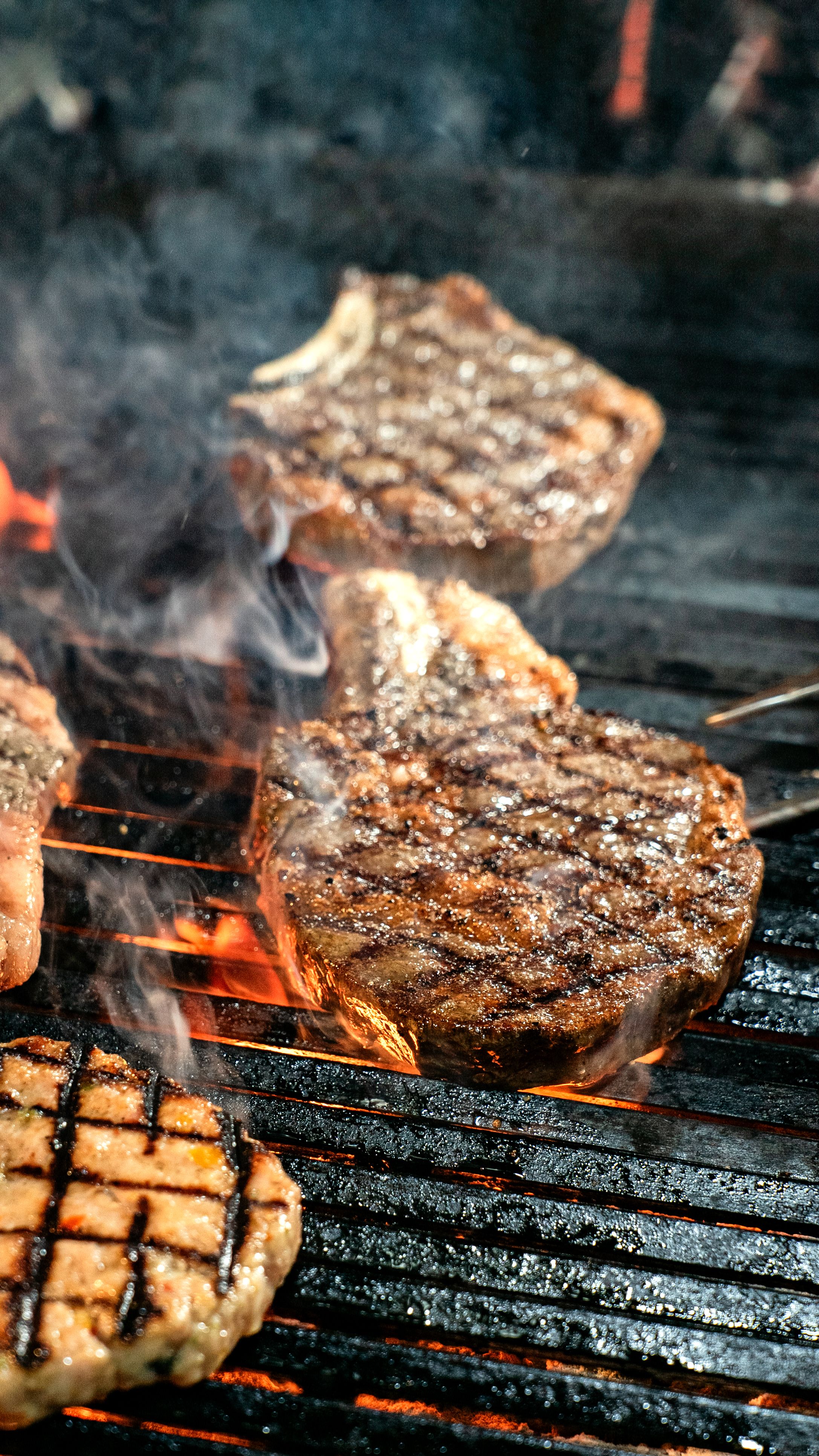 Juicy Steaks Grilling on an Open Flame · Free Stock Photo