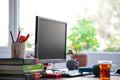 Free Black Flat Screen Computer Monitor on Brown Wooden Desk Stock Photo