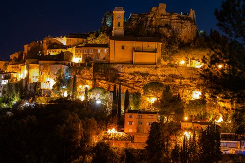 Free Beautiful night view of a hillside village with warm lights illuminating the architecture. Stock Photo