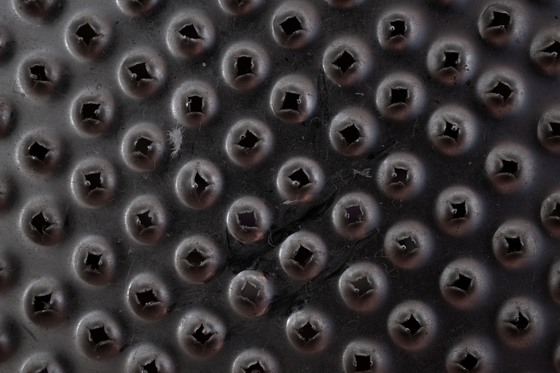 Studded black surface macro by Tomas Asurmendi on Pexels