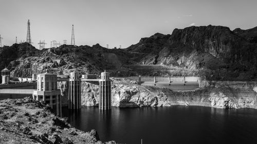 Free A stunning black and white photograph showcasing the iconic Hoover Dam and its rugged surroundings. Stock Photo
