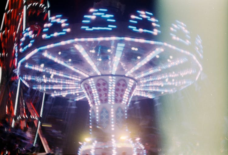 Blue And White Lights On Carnival Ride During Night Time