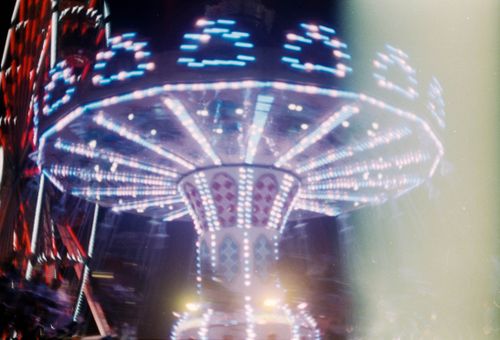 Free Dazzling long exposure of an illuminated amusement ride in Cluj-Napoca at night. Stock Photo