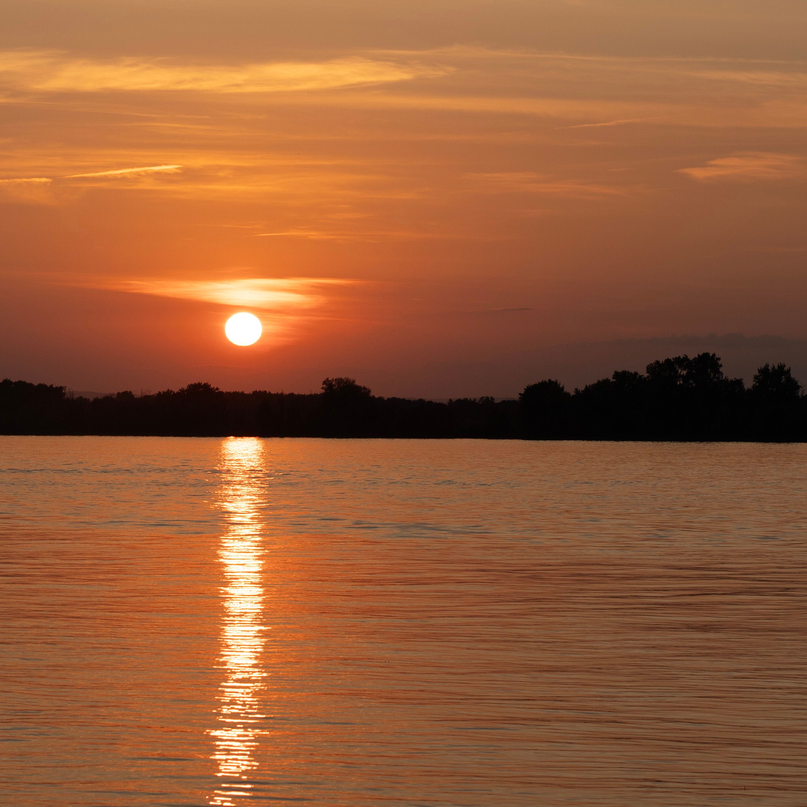 Peaceful sunset view over the Ottawa River with vibrant sky reflection.