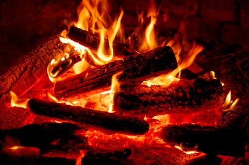 Free Close-up of a warm and inviting campfire at night, showcasing vibrant flames and glowing embers. Stock Photo