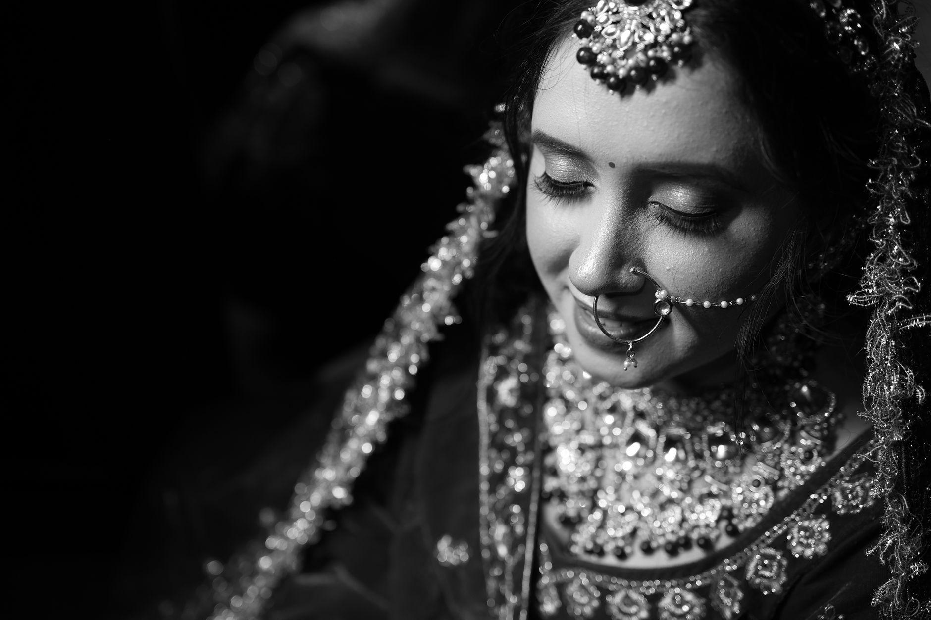 Stunning black and white portrait capturing the elegance of a traditional Indian bride.