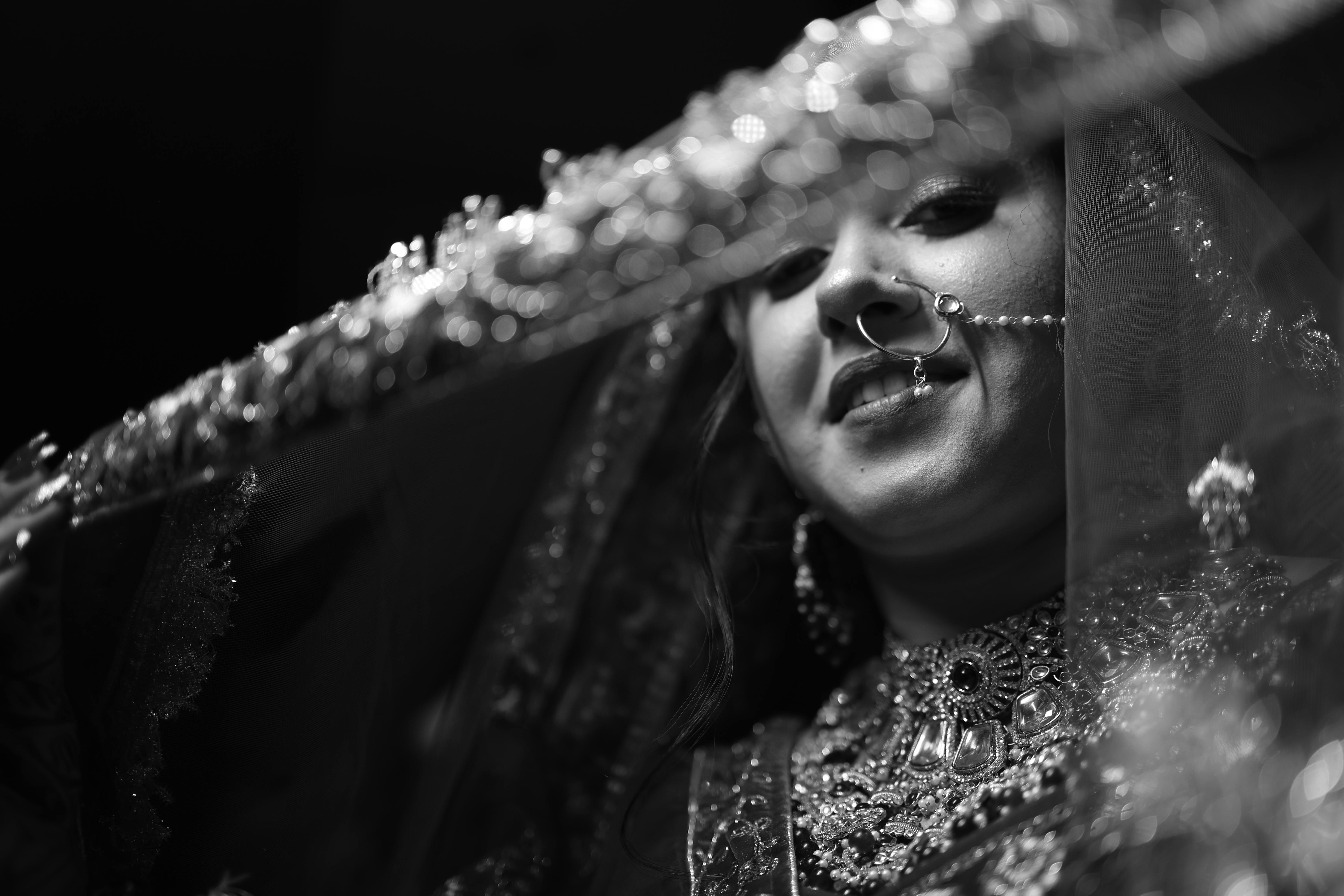 Δωρεάν Ένα κοντινό ασπρόμαυρο πορτρέτο μιας χαμογελαστής Ινδής νύφης που φοράει παραδοσιακά κοσμήματα. Φωτογραφία από στοκ φωτογραφιών