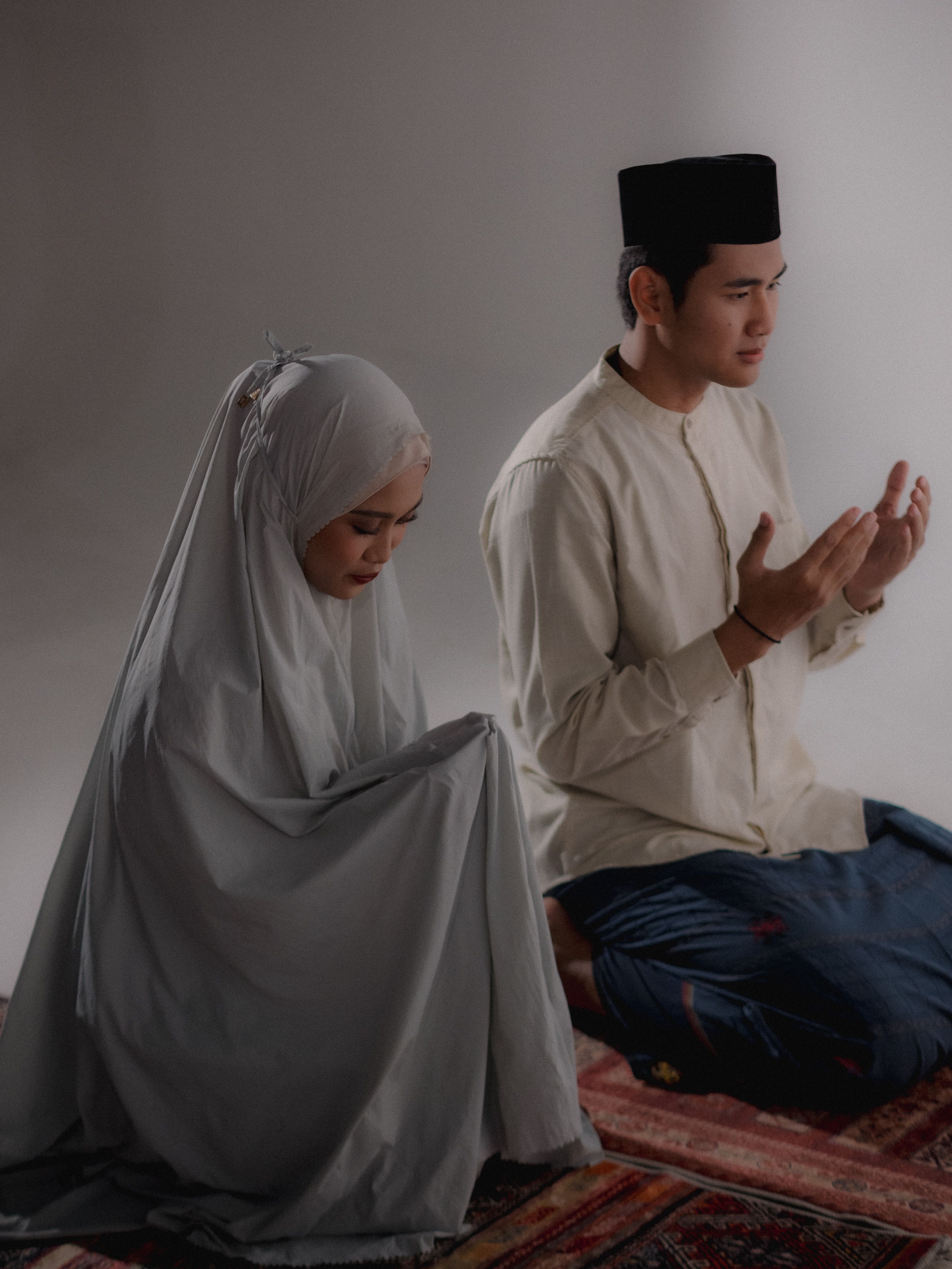 Traditional Muslim Couple Praying Indoors · Free Stock Photo