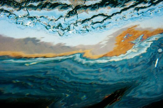 Vibrant abstract art with wave and ocean motifs, full of dynamic energy and colors, evoking a sense of movement.