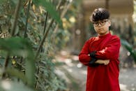Young Boy in Red Traditional Attire Outdoors