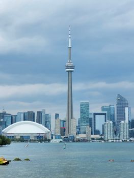Breathtaking view of Toronto skyline featuring CN Tower and waterfront under overcast sky.