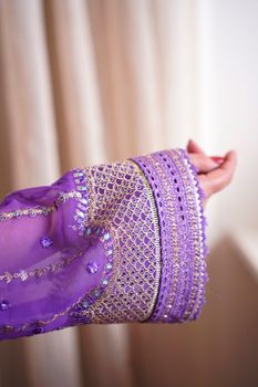 Close-up of a purple embroidered sleeve showcasing intricate design, shot in Lahore, Pakistan.