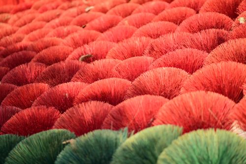 Free Close-up of red and green incense sticks arranged in a colorful and textured pattern. Stock Photo