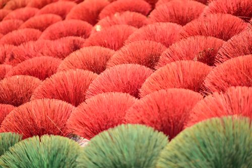 Free Abstract close-up of red and green incense sticks arranged neatly in rows. Stock Photo