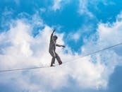 High Wire Performer Balancing with Clouds