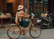Woman Riding Bicycle in Đà Nẵng Street Scene