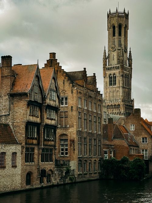 Free Captivating view of the Belfry of Bruges and historic canal houses in Brugge, Belgium. Stock Photo