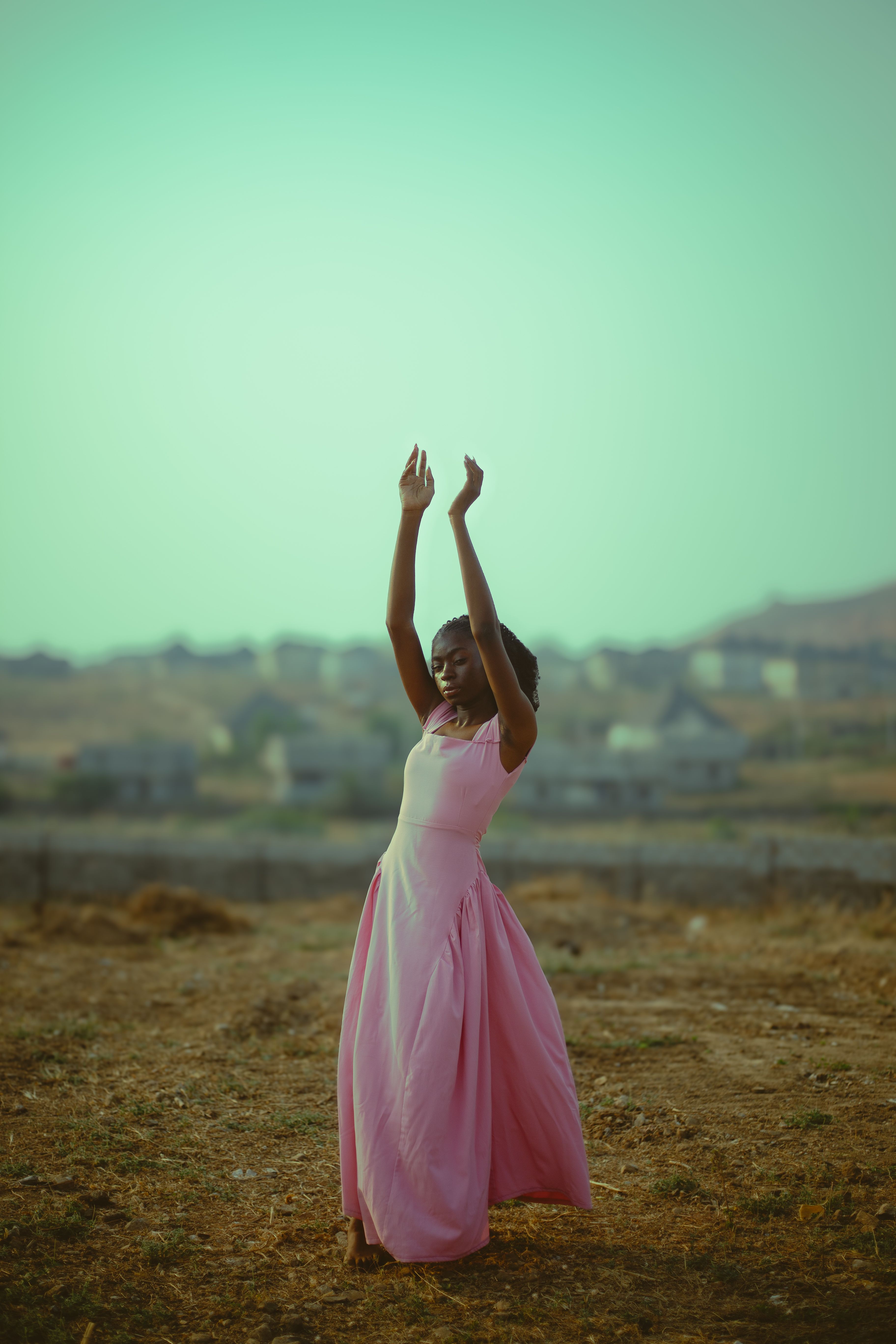 Elegant Woman Posing Outdoors in Pink Dress · Free Stock Photo