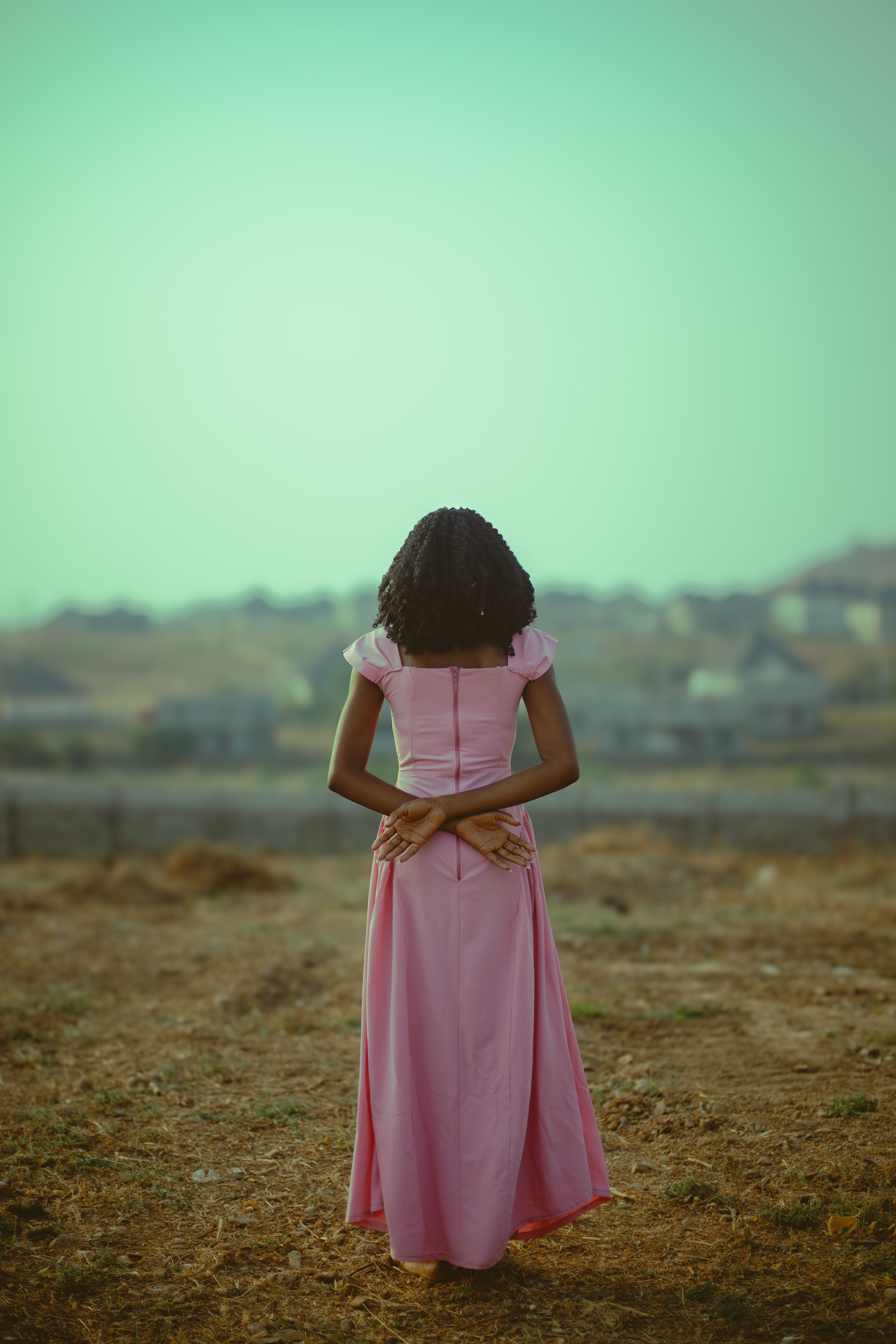 Woman in Pink Dress Outdoors at Twilight · Free Stock Photo