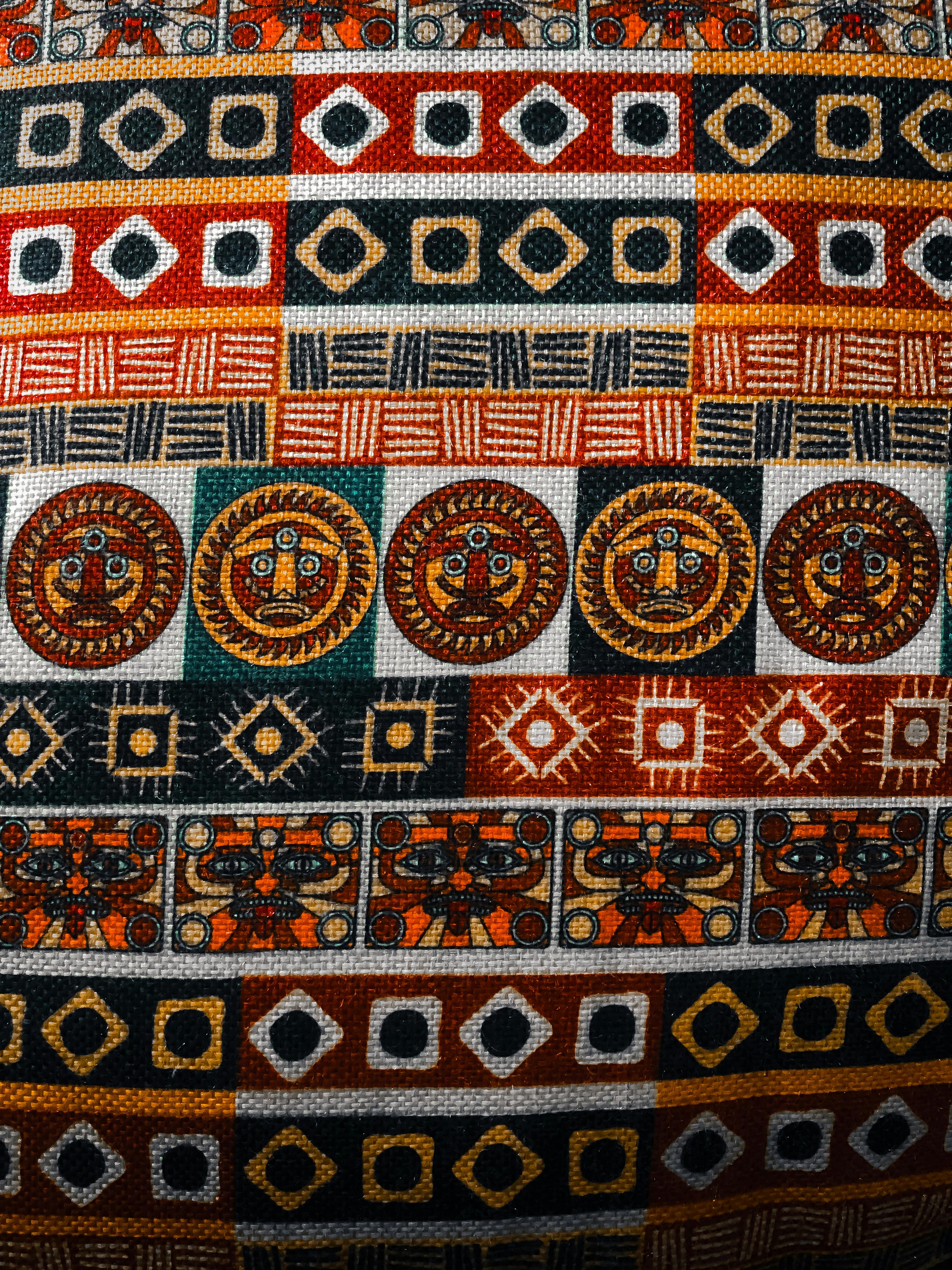 Free Vibrant fabric with geometric and tribal motifs in red, orange, and black. Stock Photo
