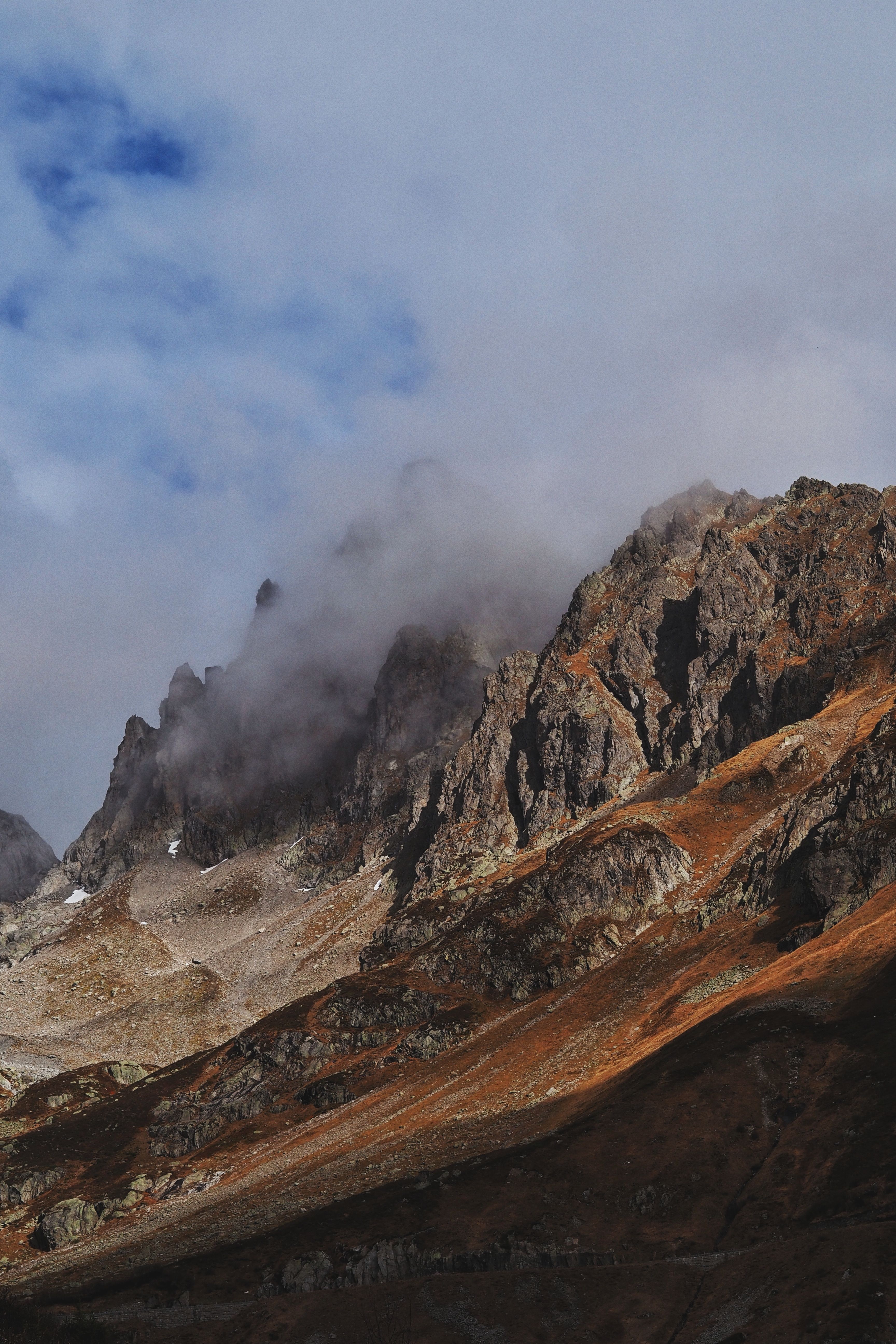 Capture of rugged mountain peaks and clouds in Innertkirchen, Bern, Switzerland.