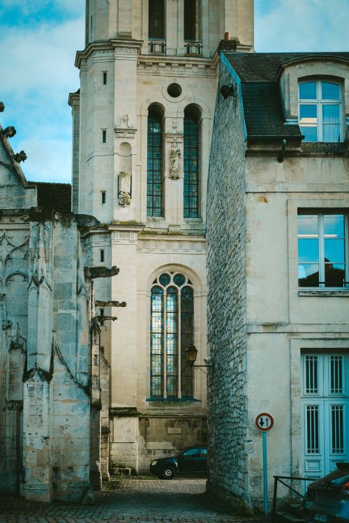 Free Capture of a historic church tower amidst medieval architecture, highlighting intricate stone details. Stock Photo